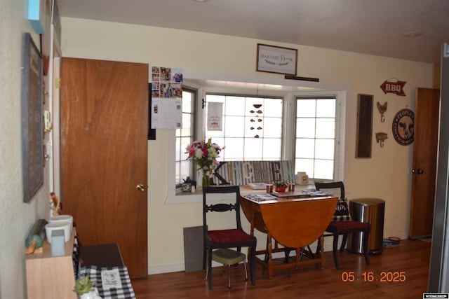 dining space with wood finished floors