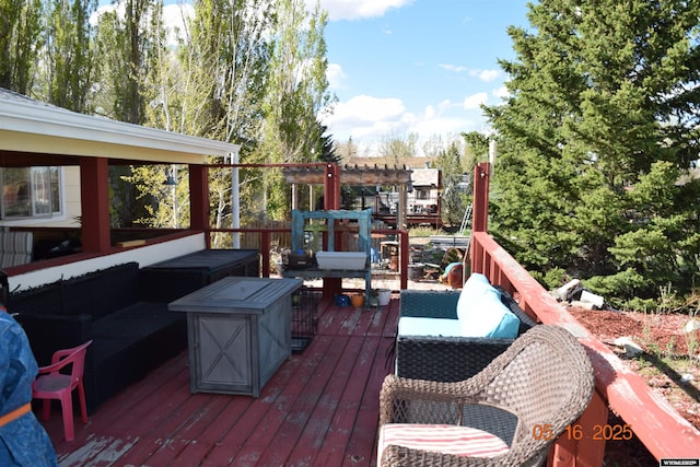 wooden terrace featuring an outdoor hangout area and a pergola