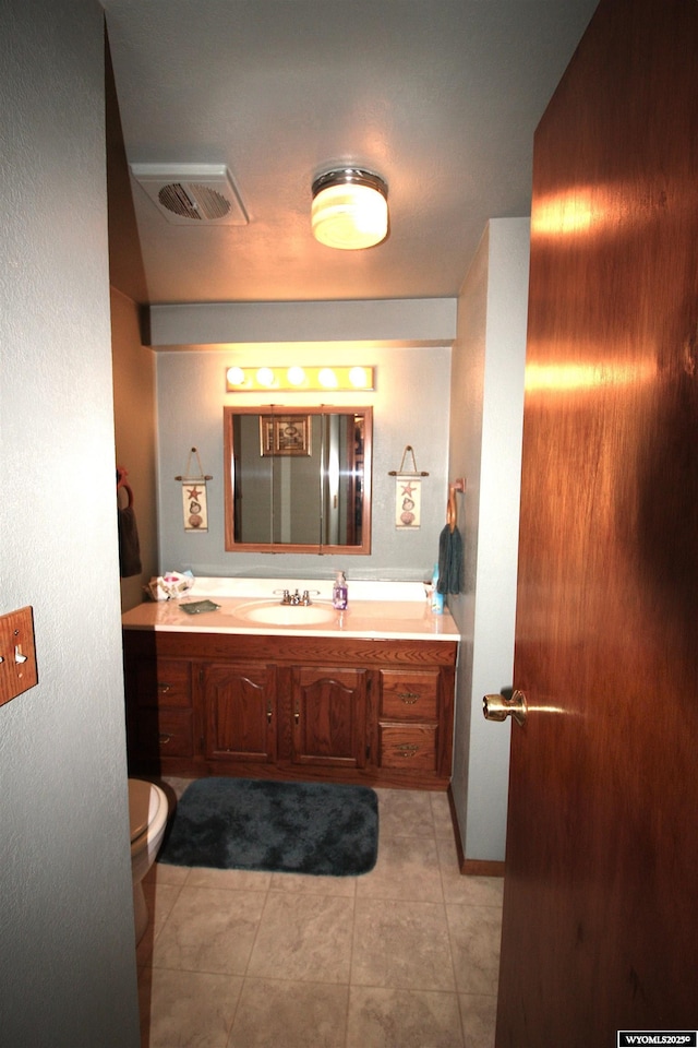 800 E 30th Ave, Torrington, WY 82240 - bathroom with toilet, vanity, and tile patterned floors