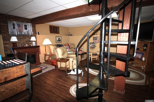 800 E 30th Ave, Torrington, WY 82240 - exercise area featuring wood finished floors, a paneled ceiling, and a glass covered fireplace
