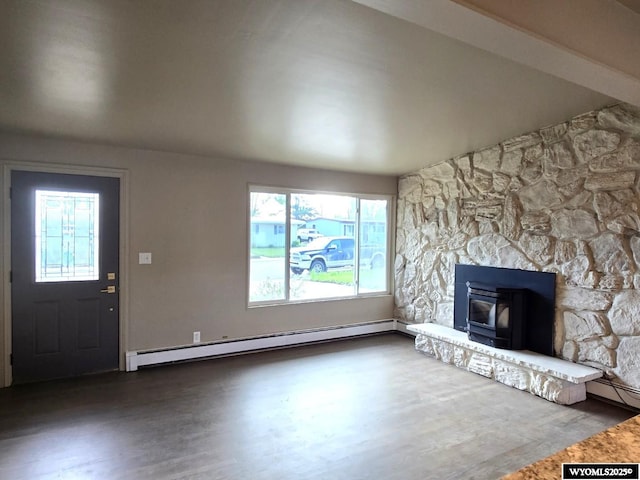 unfurnished living room featuring a wood stove, baseboard heating, and wood finished floors