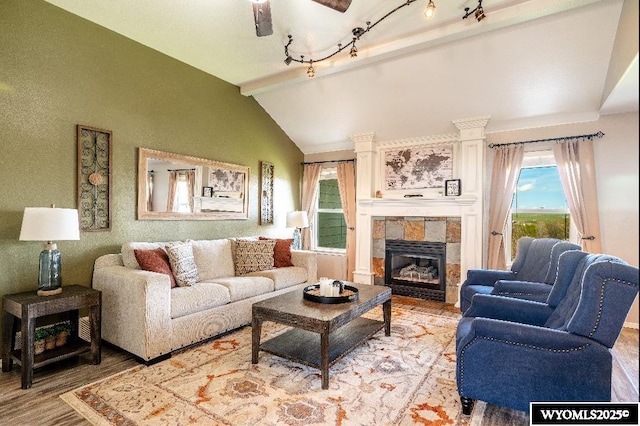 1705 N Heights Cir, Sheridan, WY 82801 - living area with light wood-style flooring, a tiled fireplace, and a ceiling fan