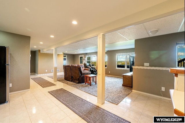1705 N Heights Cir, Sheridan, WY 82801 - basement with freestanding refrigerator, recessed lighting, light tile patterned floors, and baseboards