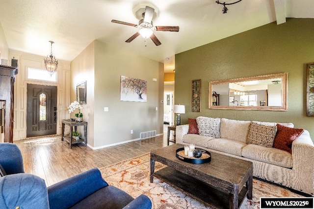 1705 N Heights Cir, Sheridan, WY 82801 - living area with wood finished floors, healthy amount of natural light, a ceiling fan, beam ceiling, and high vaulted ceiling