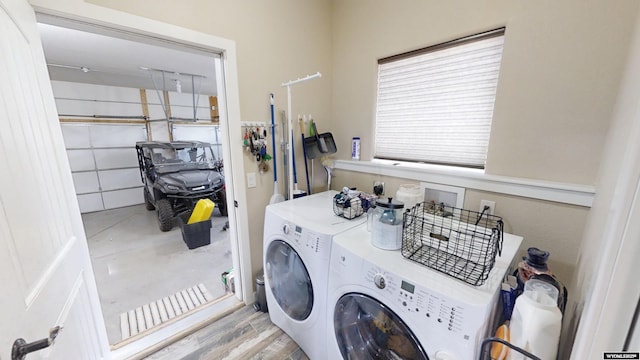 laundry room featuring independent washer and dryer and wood finished floors