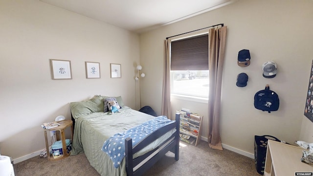 carpeted bedroom featuring baseboards