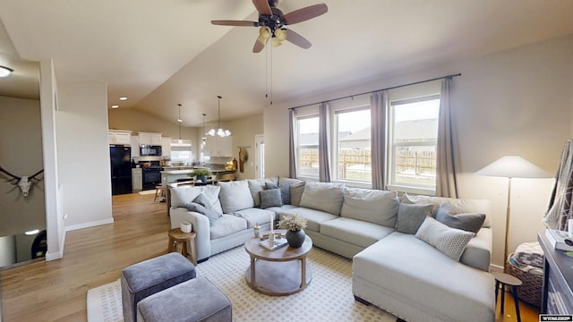 living room featuring light wood-style flooring, lofted ceiling, and a ceiling fan