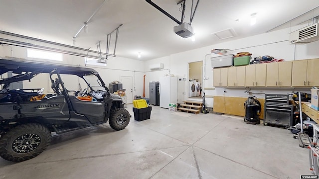 garage featuring independent washer and dryer and a garage door opener
