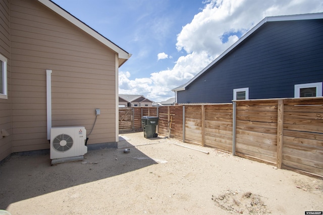 view of yard with ac unit and fence