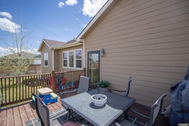 wooden deck featuring outdoor dining space and fence