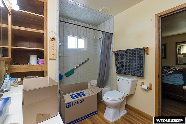 508 Sidney St, Rock Springs, WY 82901 - full bathroom with wood finished floors, toilet, and shower / tub combo