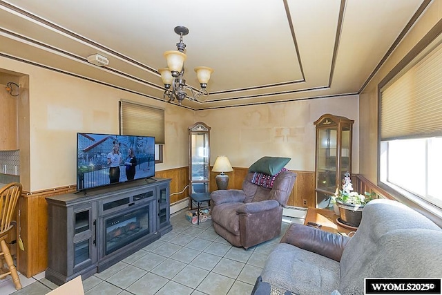 508 Sidney St, Rock Springs, WY 82901 - living area featuring a baseboard radiator, wainscoting, light tile patterned floors, a chandelier, and a tray ceiling