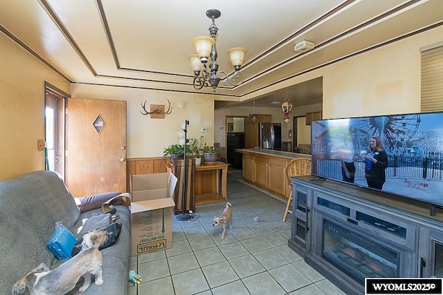 508 Sidney St, Rock Springs, WY 82901 - living area with a chandelier, light tile patterned flooring, wainscoting, and wooden walls