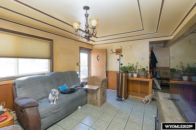 508 Sidney St, Rock Springs, WY 82901 - living area featuring a chandelier, light tile patterned floors, wainscoting, and a tray ceiling