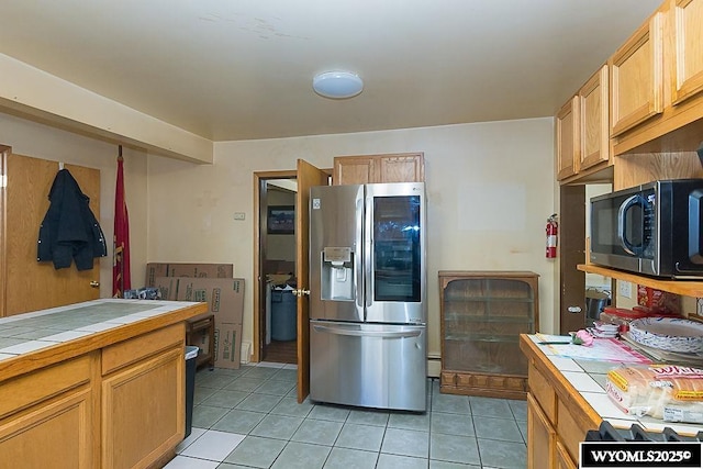 508 Sidney St, Rock Springs, WY 82901 - kitchen with stainless steel refrigerator with ice dispenser, tile counters, and light tile patterned floors