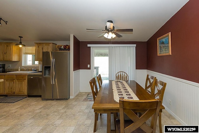 15 Greve Cir, Rock Springs, WY 82901 - dining area featuring a wainscoted wall, ceiling fan, and stone tile flooring