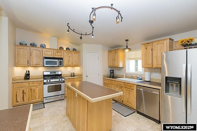 15 Greve Cir, Rock Springs, WY 82901 - kitchen with appliances with stainless steel finishes, a sink, a kitchen island, pendant lighting, and light brown cabinets