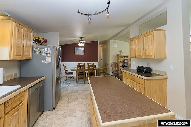 15 Greve Cir, Rock Springs, WY 82901 - kitchen featuring stainless steel appliances, ceiling fan, light brown cabinetry, a kitchen island, and stone finish flooring