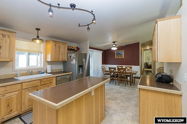 15 Greve Cir, Rock Springs, WY 82901 - kitchen featuring a sink, stainless steel appliances, a ceiling fan, light brown cabinetry, and a kitchen island
