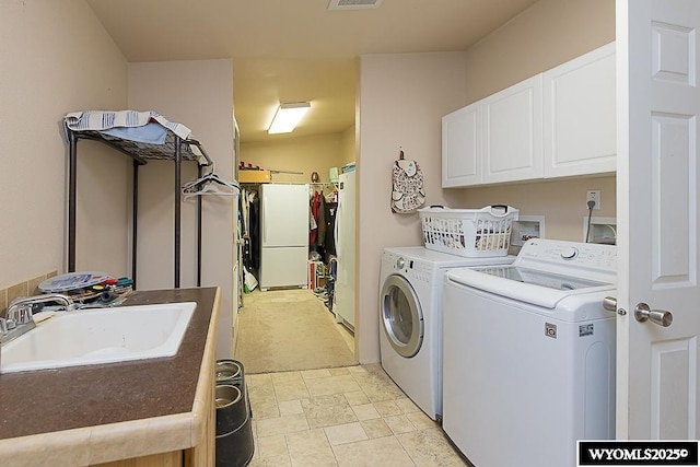 15 Greve Cir, Rock Springs, WY 82901 - washroom with cabinet space, separate washer and dryer, and light stone finish floors