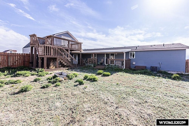 15 Greve Cir, Rock Springs, WY 82901 - rear view of house with a deck, fence, central AC unit, and stairs