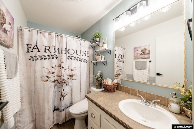 750 N Adams Ave, Buffalo, WY 82834 - full bathroom with toilet, vanity, and a shower with shower curtain
