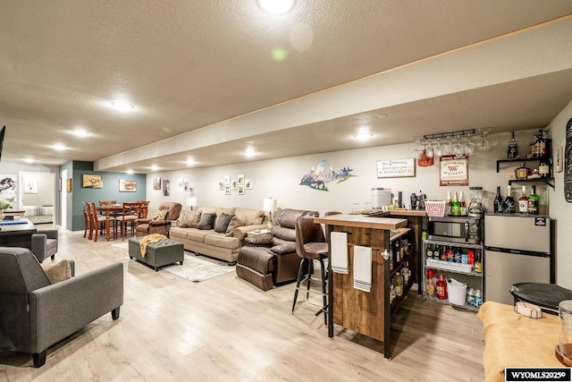 750 N Adams Ave, Buffalo, WY 82834 - living room with bar area, a textured ceiling, and wood finished floors