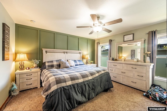750 N Adams Ave, Buffalo, WY 82834 - bedroom with light carpet, a decorative wall, and ceiling fan