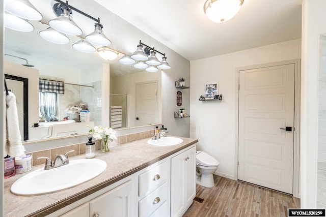 750 N Adams Ave, Buffalo, WY 82834 - bathroom with a shower stall, toilet, double vanity, and wood finished floors