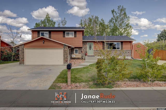 tri-level home with an attached garage, driveway, and brick siding
