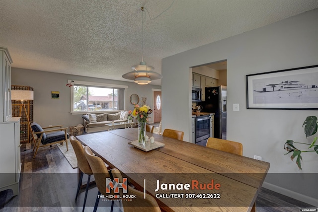 dining area with a textured ceiling, dark wood-type flooring, and baseboards