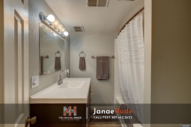 full bath featuring vanity and shower / tub combo with curtain