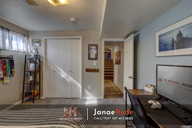 carpeted entrance foyer featuring baseboards and stairway