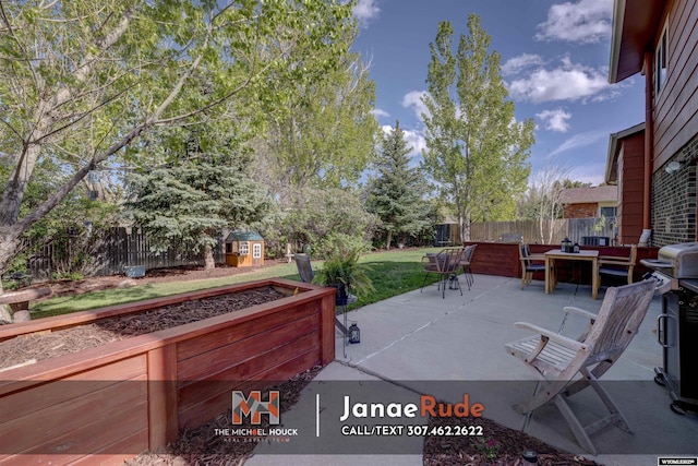 view of patio / terrace featuring a storage unit, an outdoor structure, outdoor dining space, and a grill