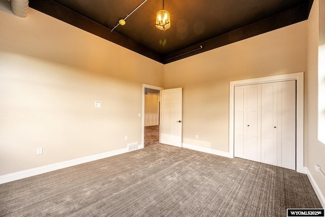 1030 N Main St, Sheridan, WY 82801 - unfurnished bedroom with carpet, a high ceiling, a closet, and baseboards