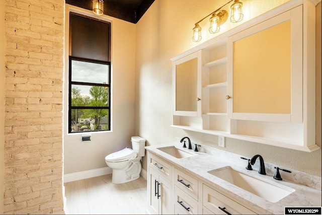 1030 N Main St, Sheridan, WY 82801 - full bath featuring toilet, wood finished floors, double vanity, and baseboards