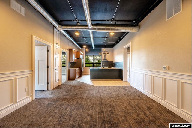 1030 N Main St, Sheridan, WY 82801 - kitchen featuring carpet flooring, a decorative wall, freestanding refrigerator, a sink, and a desk