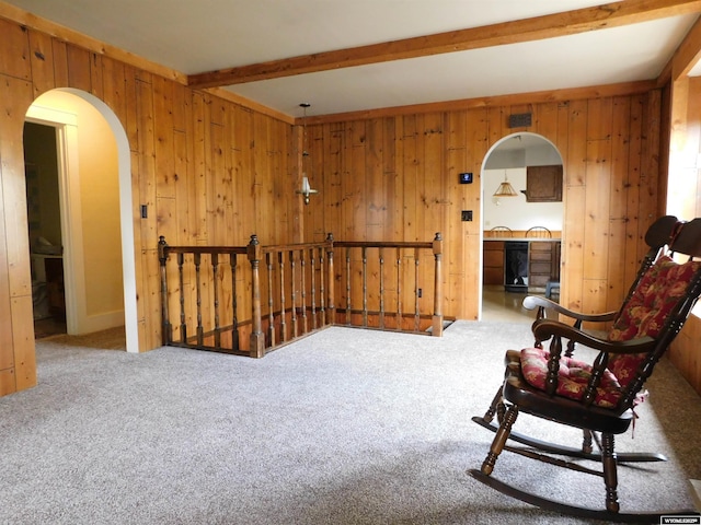 295 N 1st Street E, St, Green River, WY 82935 - sitting room with an upstairs landing, wooden walls, carpet floors, arched walkways, and beamed ceiling