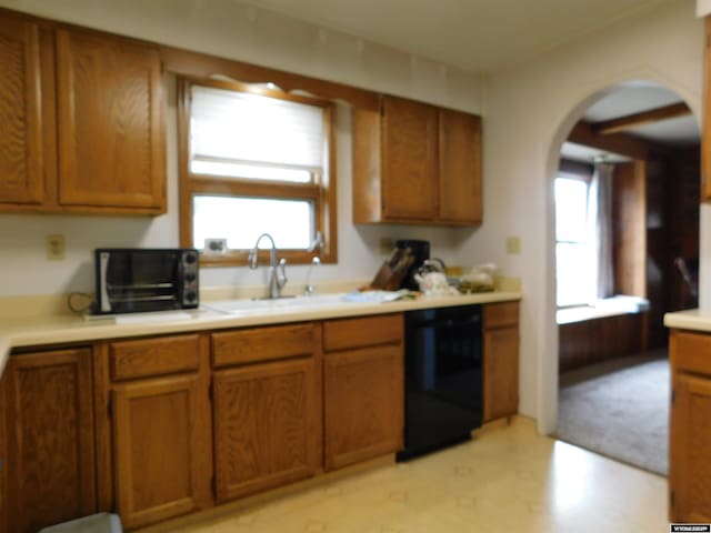 295 N 1st Street E, St, Green River, WY 82935 - kitchen featuring dishwasher, arched walkways, brown cabinetry, and a sink