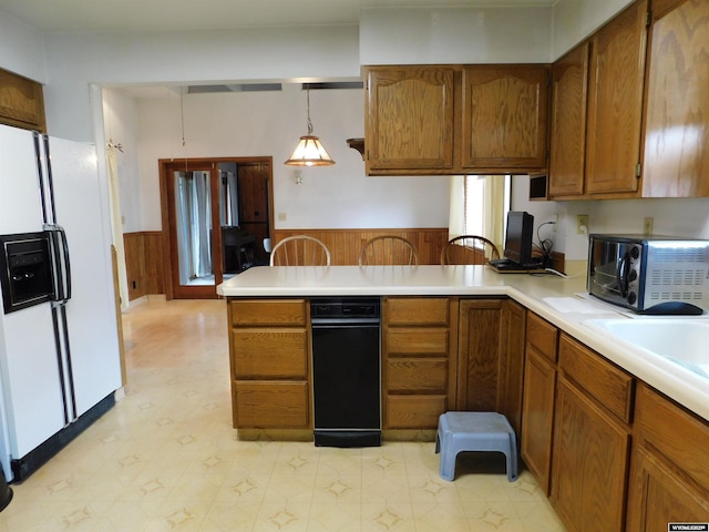 295 N 1st Street E, St, Green River, WY 82935 - kitchen with white refrigerator with ice dispenser, wainscoting, a peninsula, brown cabinets, and light countertops