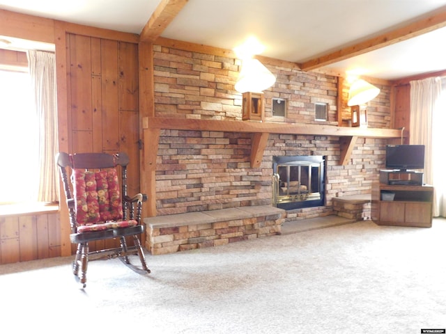 295 N 1st Street E, St, Green River, WY 82935 - living area with beam ceiling, carpet flooring, wood walls, and a stone fireplace