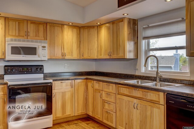 kitchen featuring white microwave, electric stove, dishwasher, a sink, and dark countertops