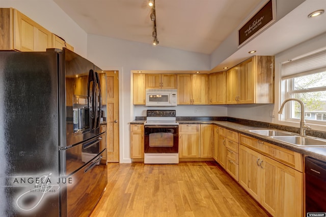 kitchen featuring black appliances, a sink, light brown cabinets, light wood finished floors, and rail lighting