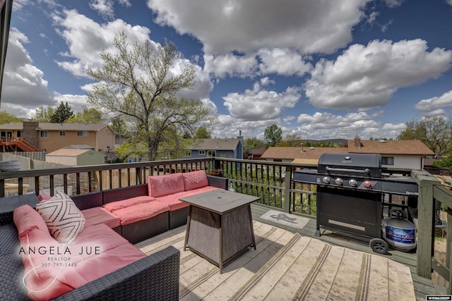 deck featuring outdoor lounge area, grilling area, and a residential view