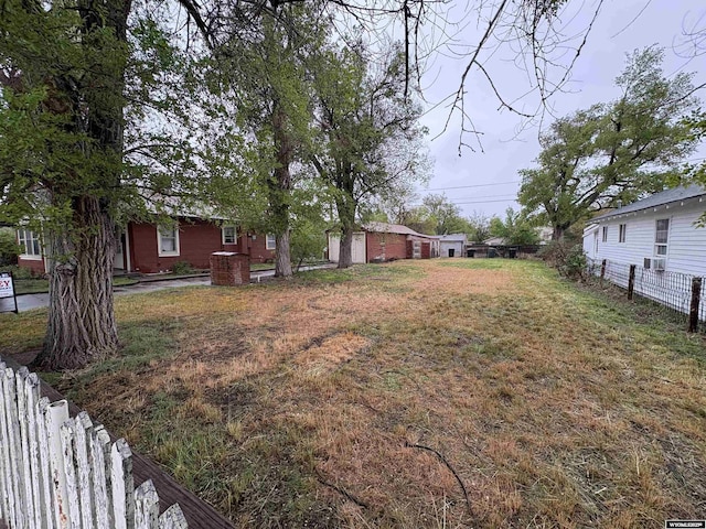 view of yard with fence and cooling unit