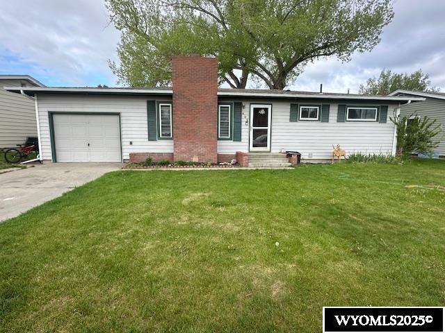 408 S 18th, Worland, WY 82401 - single story home featuring an attached garage, a chimney, concrete driveway, and a front yard