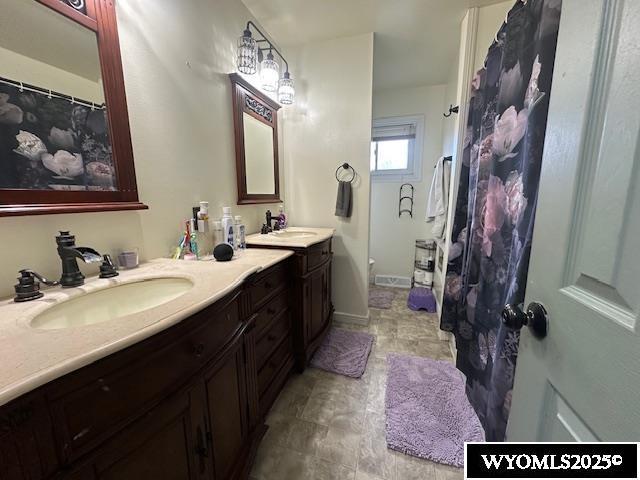 408 S 18th, Worland, WY 82401 - full bathroom featuring vanity and a shower with shower curtain