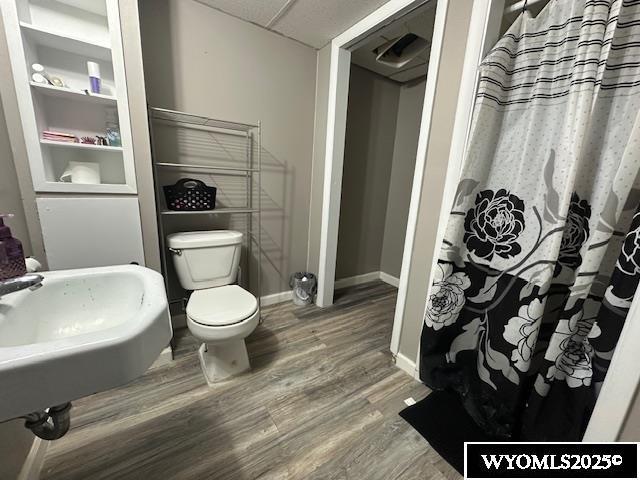 408 S 18th, Worland, WY 82401 - bathroom with wood finished floors, toilet, and baseboards