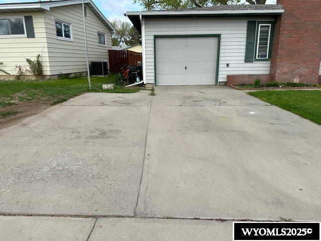 408 S 18th, Worland, WY 82401 - garage featuring central air condition unit and driveway