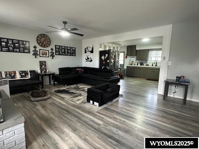 408 S 18th, Worland, WY 82401 - living area featuring a ceiling fan, wood finished floors, and baseboards